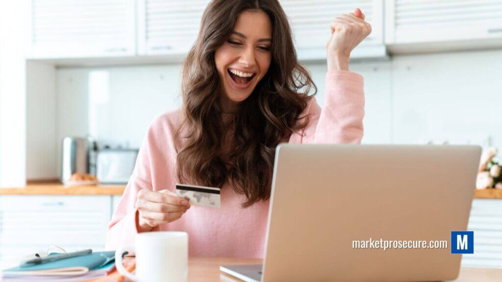 A woman in a pink sweater sits at her kitchen table, credit card in hand, eyes alight on her laptop screen. She pumps her fist with joy - she's just optimized her credit utilization ratio! Nearby, a white mug and papers complete the scene. Ready to boost your own financial health? Visit [URL] to discover game-changing tips today! #PersonalFinanceSuccess.