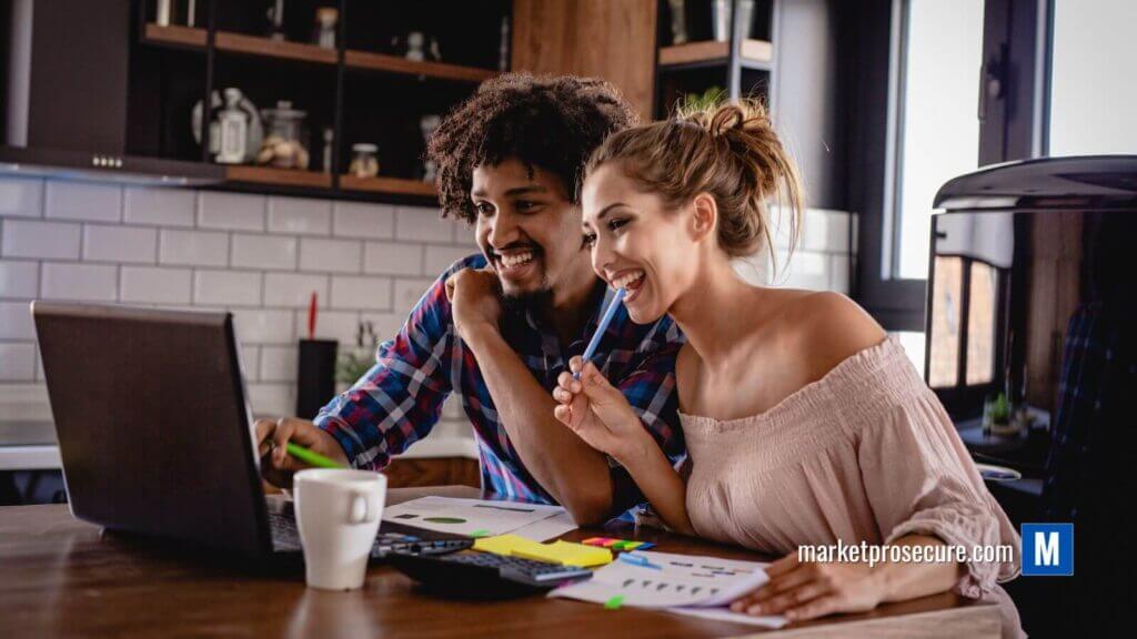 Picture this: a dynamic duo - him and her - sitting at their kitchen table, a place that's more than just for meals; it's their command center for financial freedom. They’re smiling because on the laptop screen in front of them is a treasure trove of killer budgeting tips, ready to skyrocket their savings game. Wanna know what sets this scene? A table covered in essentials - a calculator working double-time, papers full of scribbles and strategies, and colored pens marking pathways to fiscal success. The backdrop? Sleek wooden cabinets and a pristine white tile backsplash creating an ambiance that’s both functional and inspiring. This is where smart financial vibes meet actionable insights - all set to transform your budget mastery.